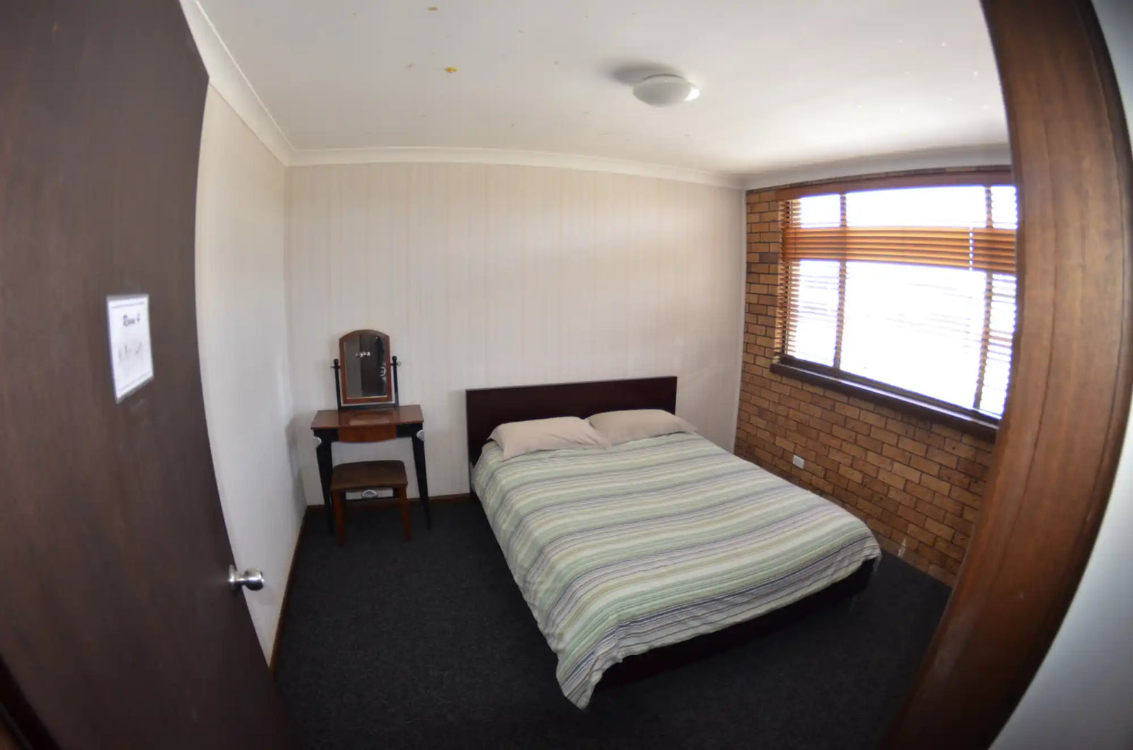 Double bed with striped bedding.