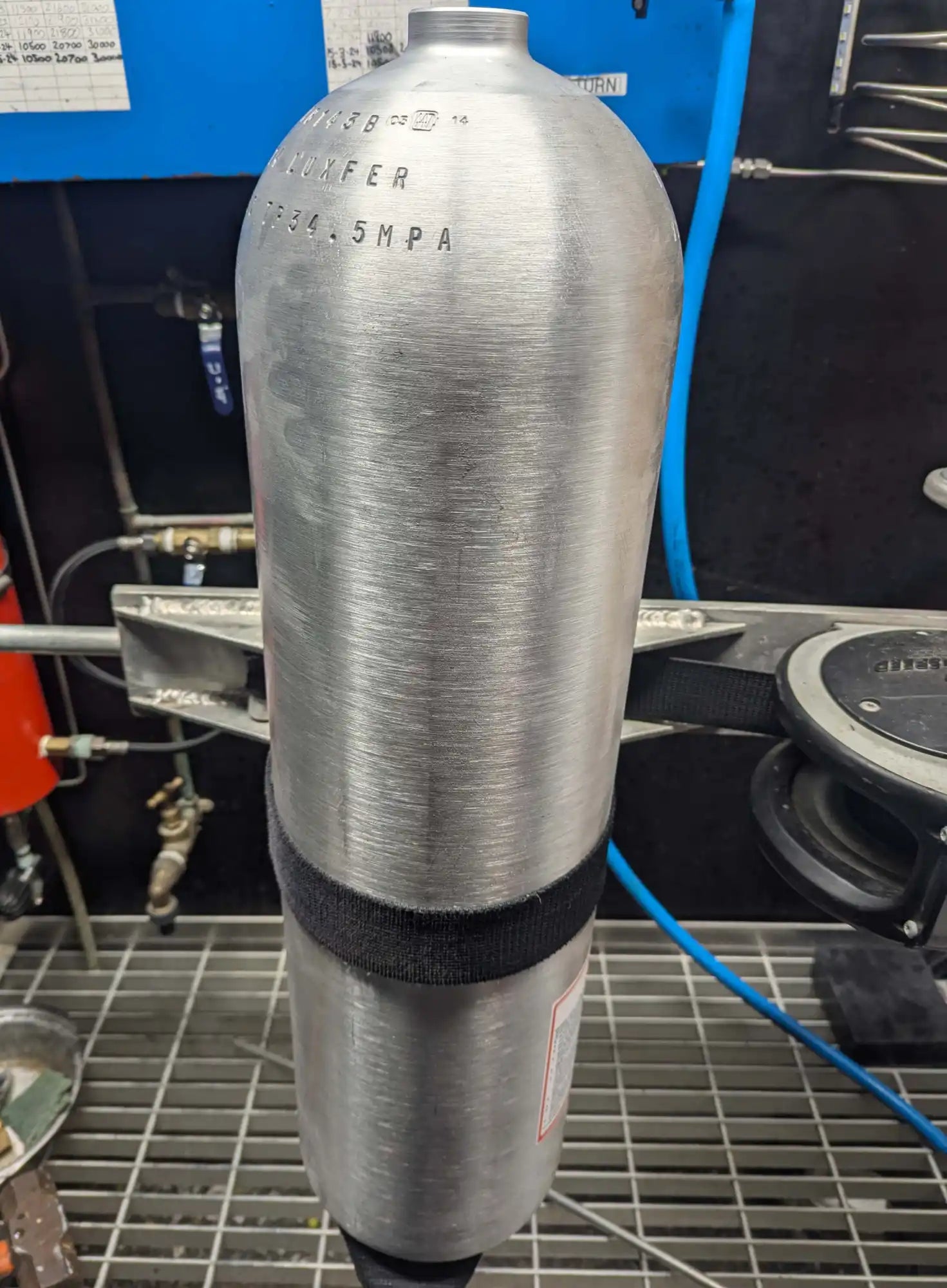 Silver metallic SCUBA tank with a black band around its middle.