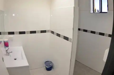 White porcelain sink mounted on a wall.